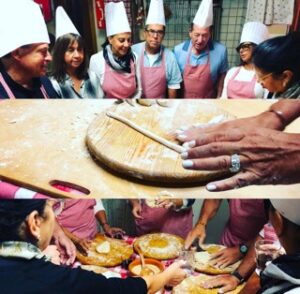 A cooking class scene with participants wearing aprons and chef hats, learning to roll and shape dough on wooden boards, guided by an instructor.